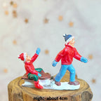 Scène de personnages pour village de Noël